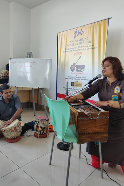 Adult students practicing guitar at AMA